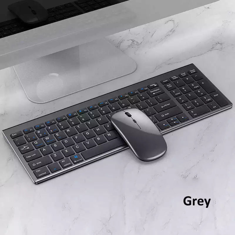 Gray keyboard and mouse set on a marble desk