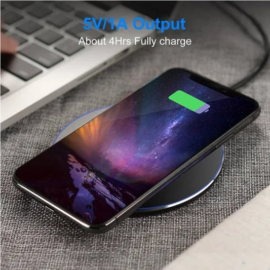 Wireless Charger with smartphone on a desk next to a keyboard