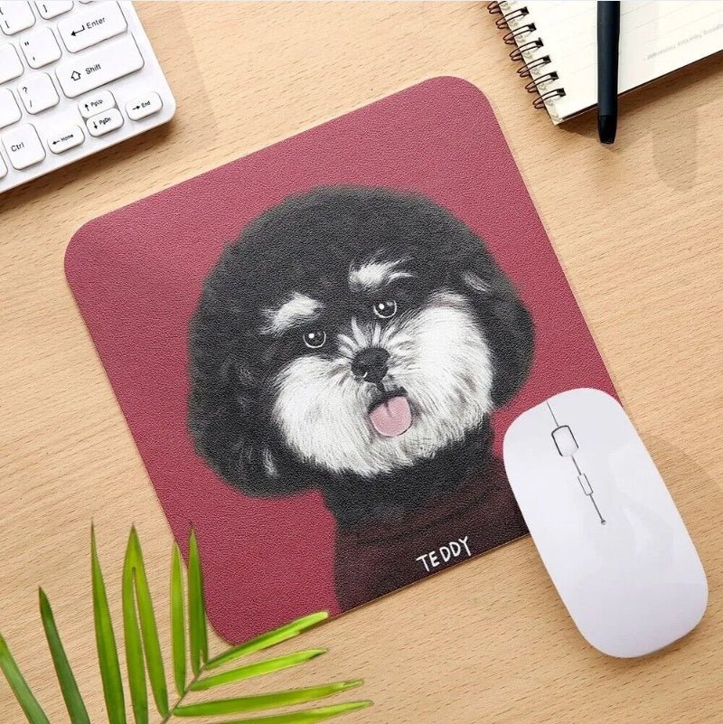 Mouse pad with a dog illustration on a desk with a computer mouse and keyboard.