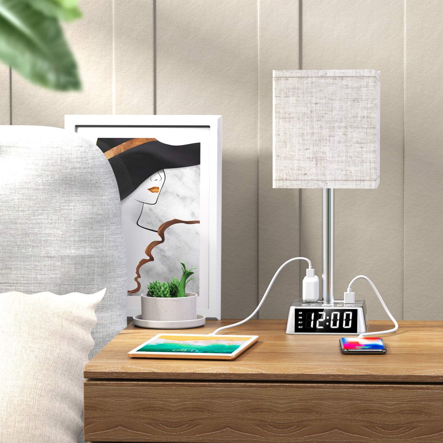 Bedside table with lamp, clock, and tablet on a wooden surface.